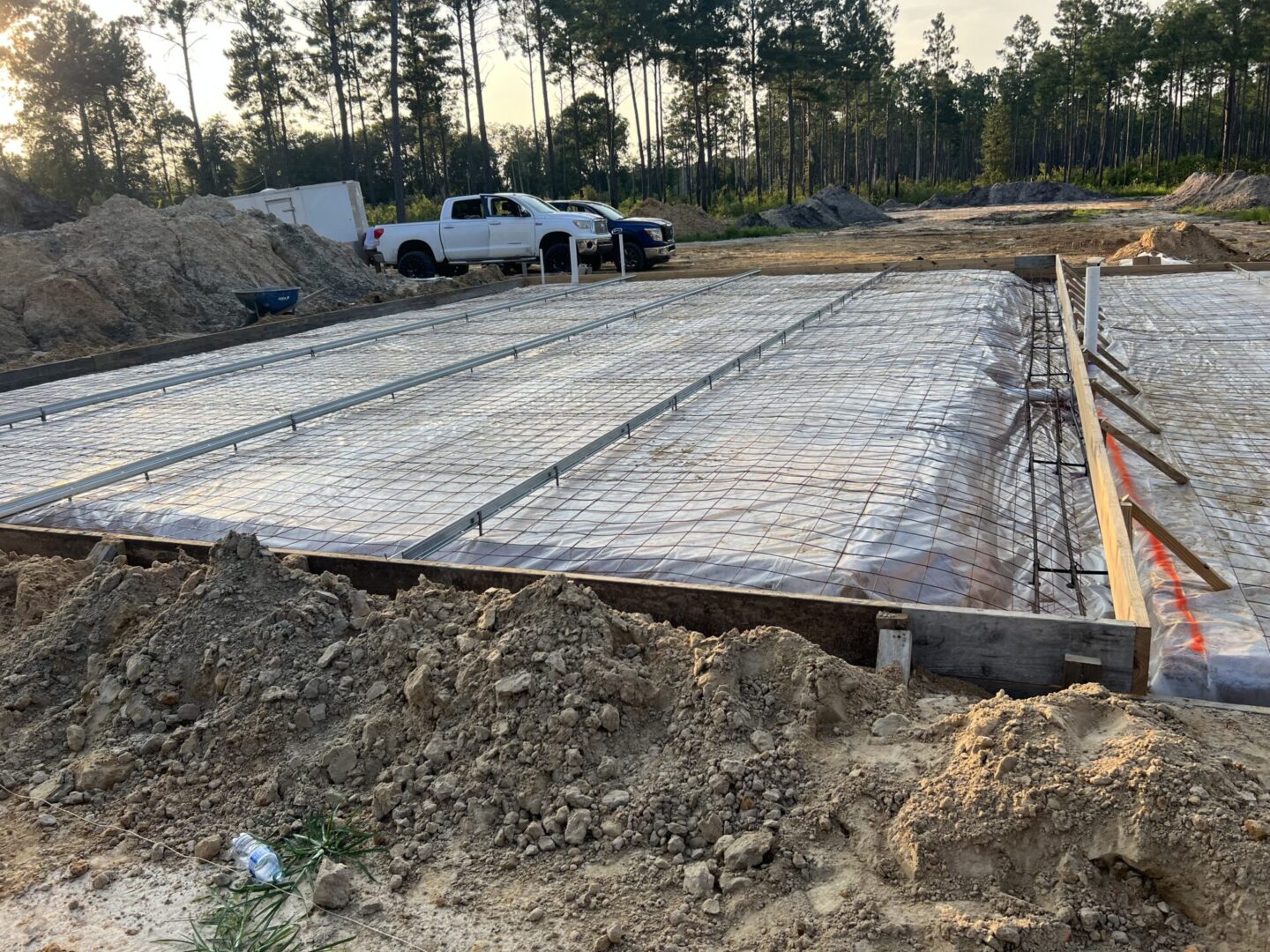 A construction site with trucks parked in the background.