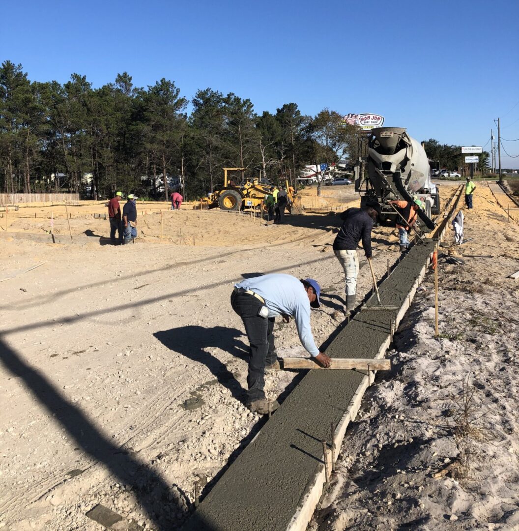 A group of people working on the side of a road.